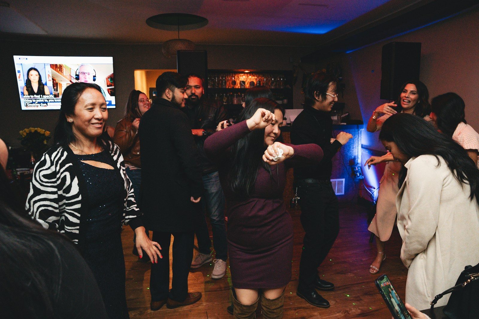A group of people dancing at a party